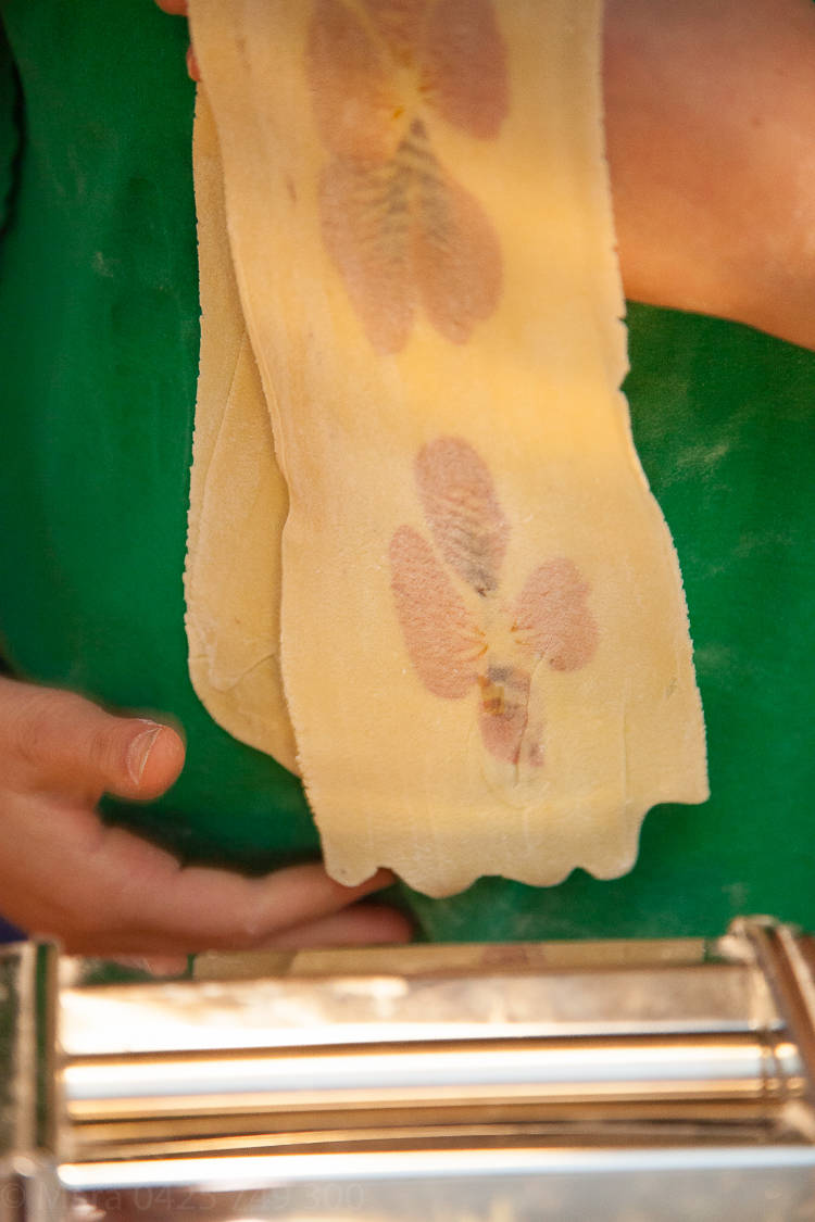The pasta sheets are passed through the varying sizes of the roller until quite thin. 